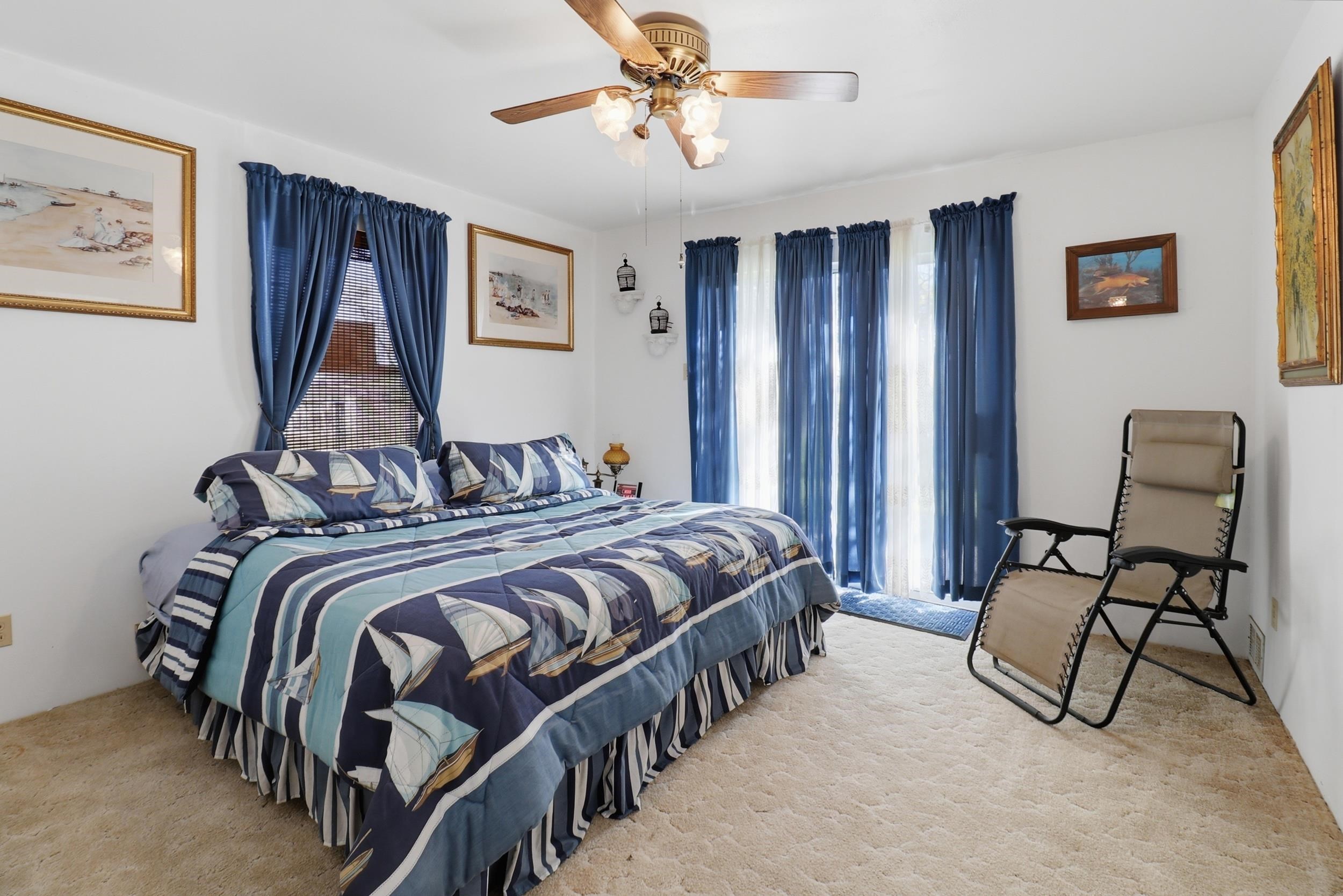 919 Lakeshore Loop Tow, TX 78672 - Photo 24 of 33 a bedroom with a bed and a chandelier
