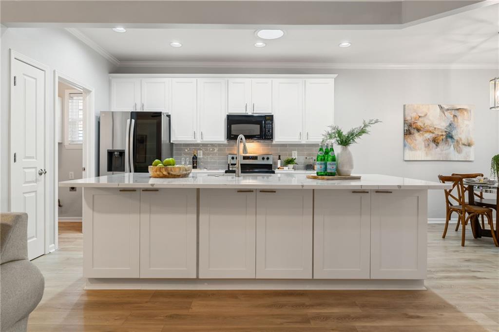 5090 Duke Drive Cumming, GA 30040 - Photo 16 of 65 a kitchen with stainless steel appliances granite countertop a refrigerator a stove and a sink