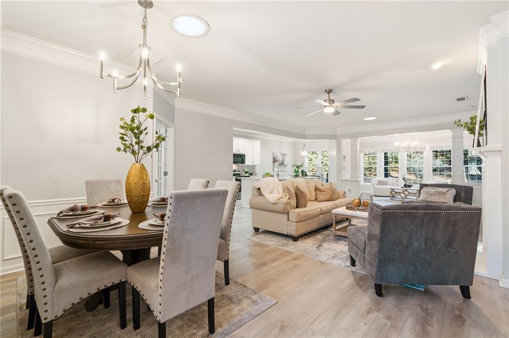 5090 Duke Drive Cumming, GA 30040 - Photo 31 of 65 a living room with furniture and a chandelier