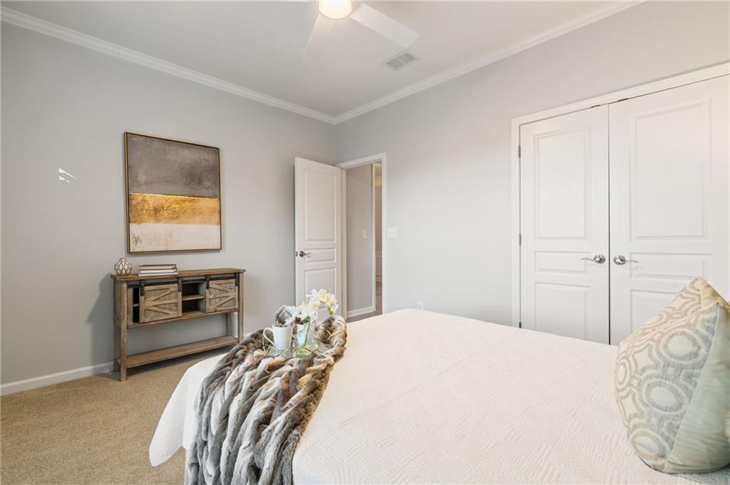 5090 Duke Drive Cumming, GA 30040 - Photo 45 of 65 a bedroom with a bed and dresser