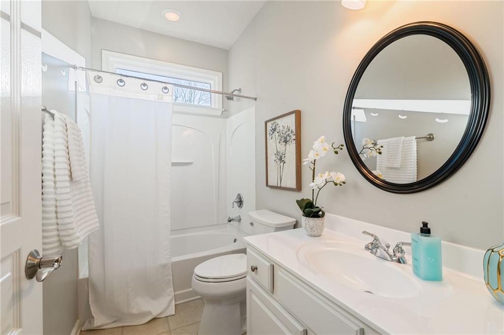 5090 Duke Drive Cumming, GA 30040 - Photo 47 of 65 a bathroom with a sink a toilet and a mirror