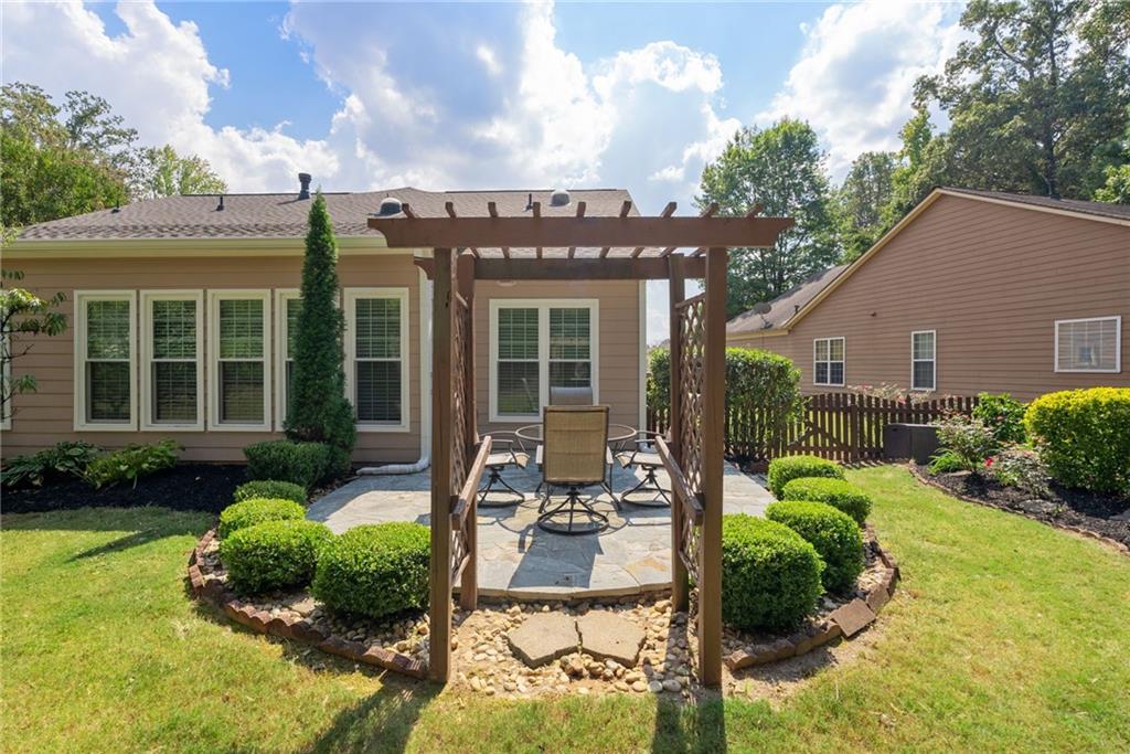 5090 Duke Drive Cumming, GA 30040 - Photo 50 of 65 a view of a house with backyard sitting area and swimming pool