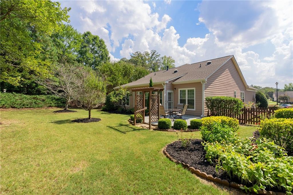 5090 Duke Drive Cumming, GA 30040 - Photo 53 of 65 a view of a house with swimming pool and sitting area