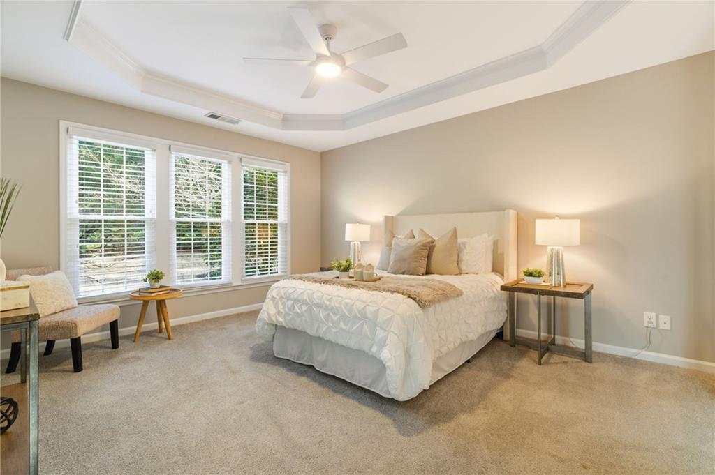 5090 Duke Drive Cumming, GA 30040 - Photo 10 of 65 a spacious bedroom with a bed and a large window