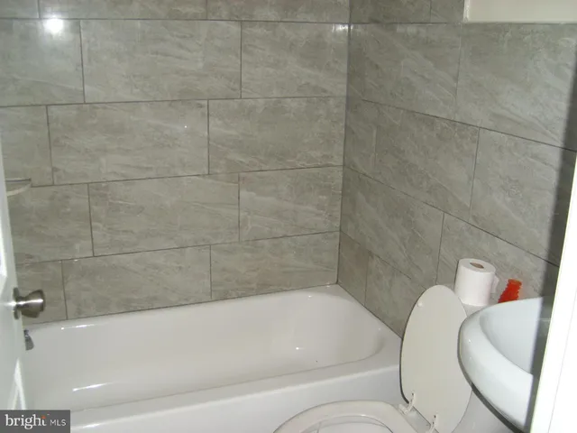 a bathroom with a bathtub and shower