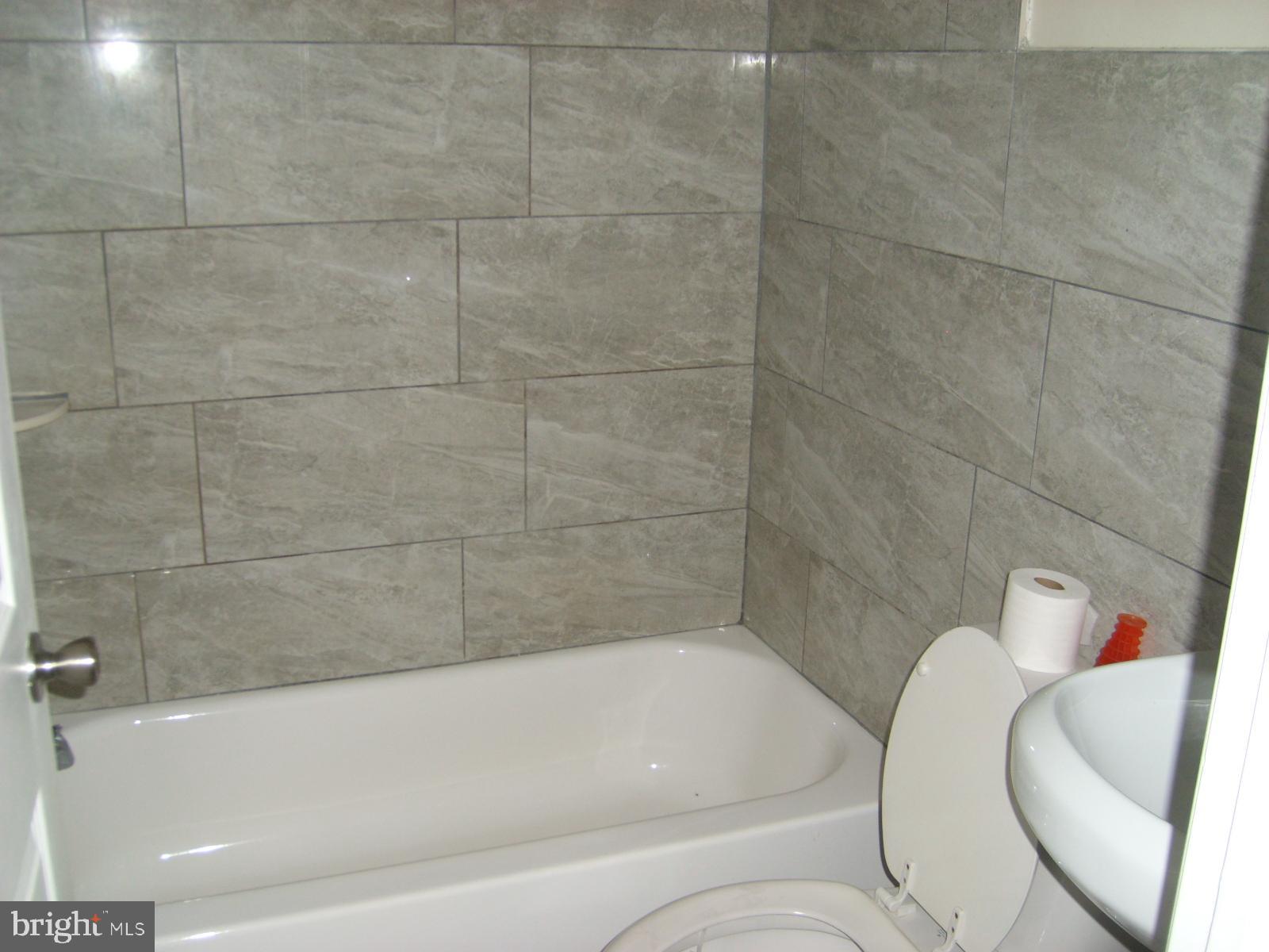 3838 Aspen Street Philadelphia, PA 19104 - Photo 4 of 15 a bathroom with a bathtub and shower