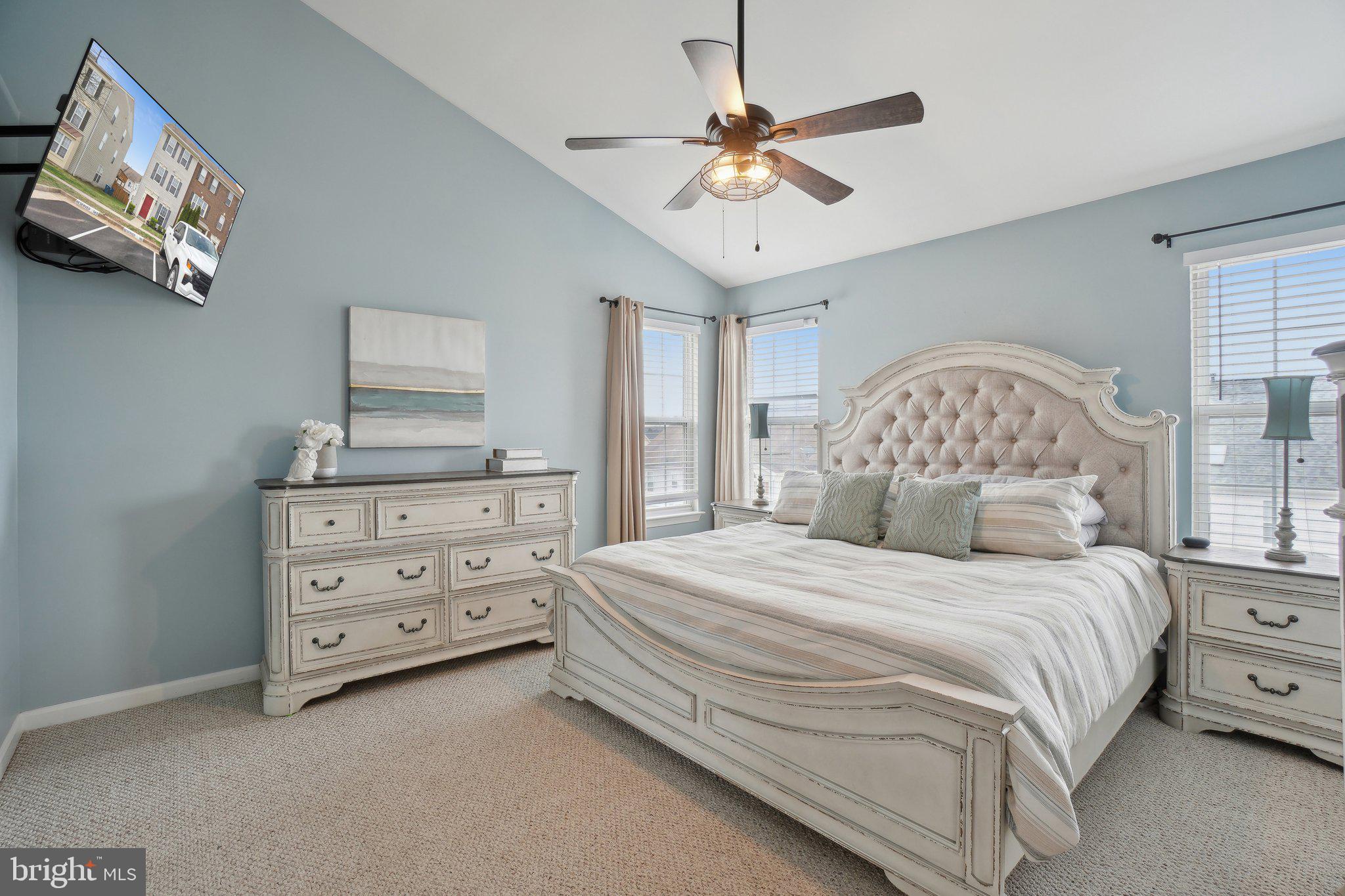 25379 Bryson Drive Chantilly, VA 20152 - Photo 17 of 28 a bedroom with a large bed and a chandelier