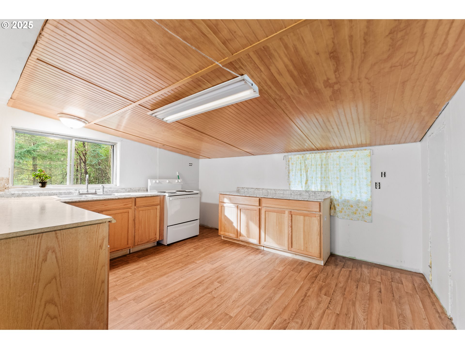 414 Callahan Road Roseburg, OR 97471 - Photo 3 of 33 a kitchen with a wooden floor and white appliances