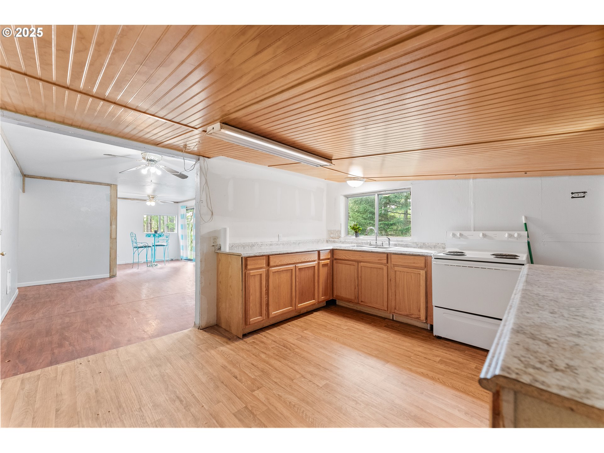 414 Callahan Road Roseburg, OR 97471 - Photo 6 of 33 a kitchen with a wooden floor and window
