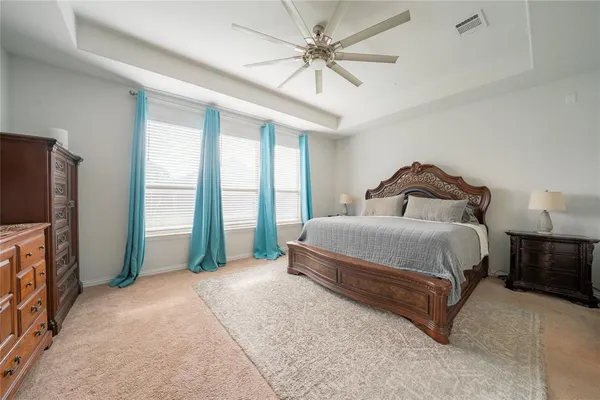 a bedroom with a bed and a chandelier