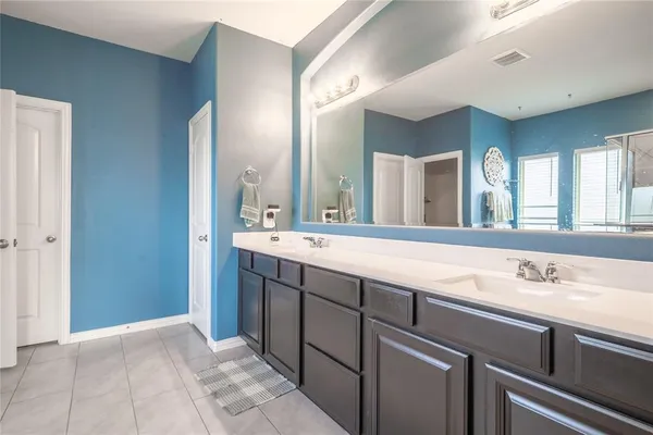 a large bathroom with a large tub and sink