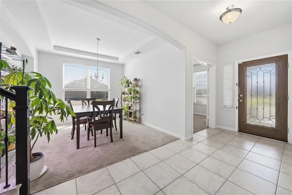 a view of a dining room with furniture and a potted plant