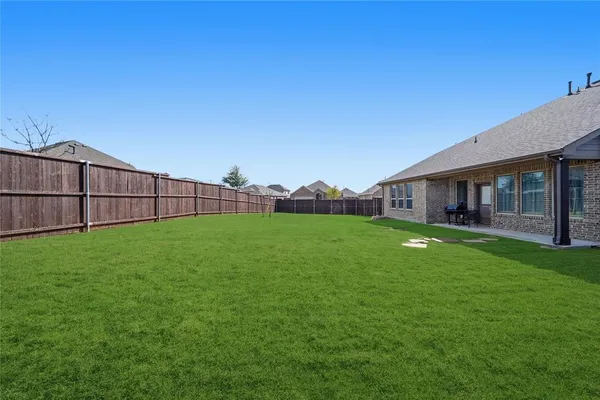 a view of a backyard with a garden and plants