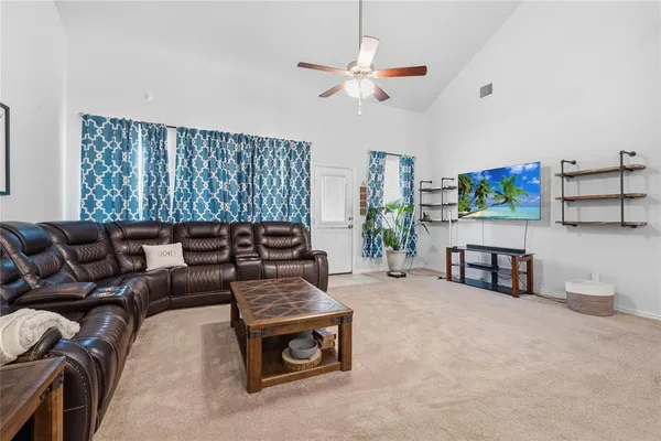 a living room with furniture and kitchen view
