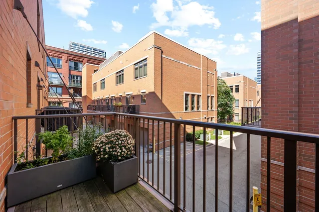 a view of a two chairs and table in the balcony