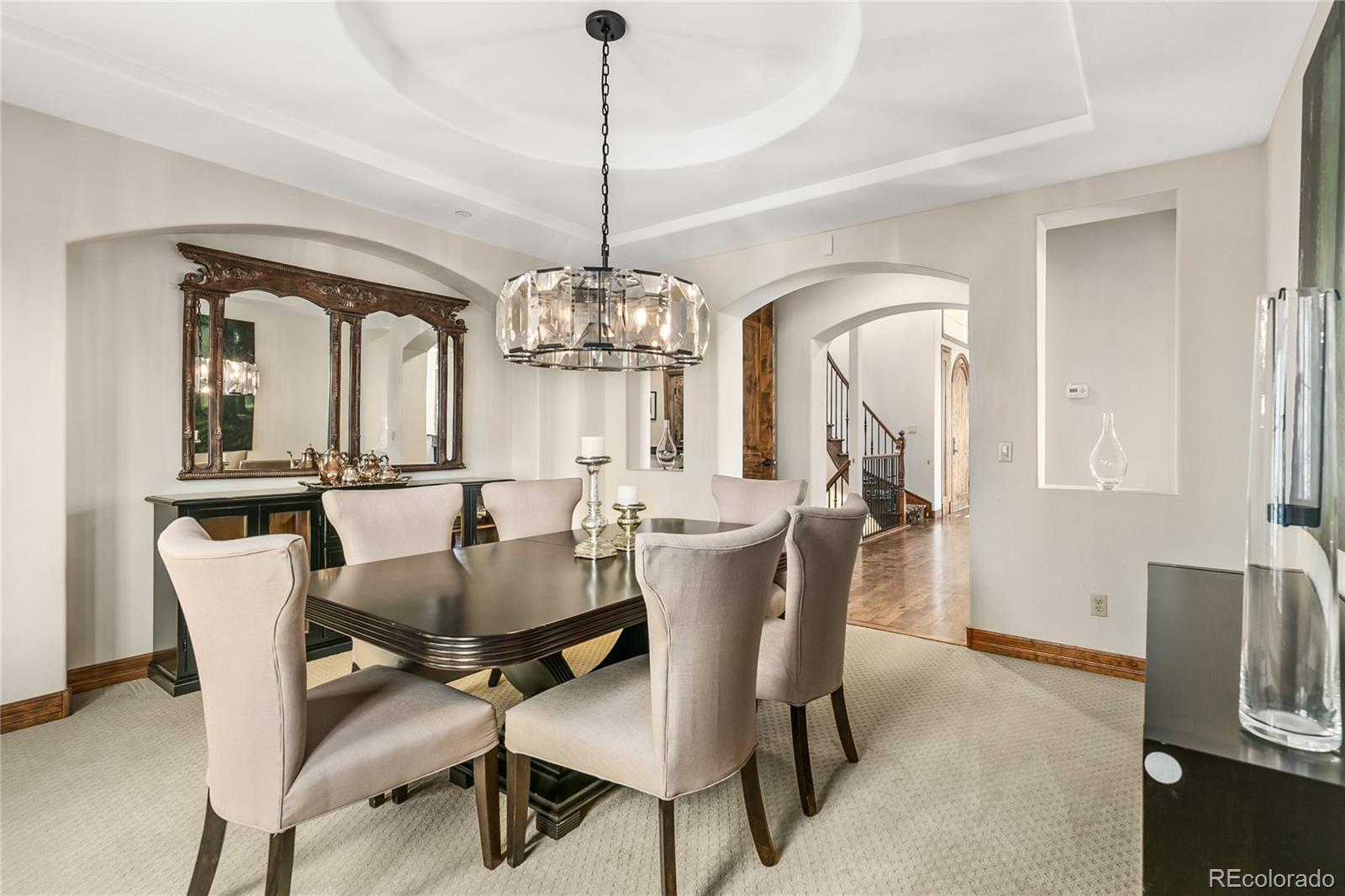 1295 Buffalo Ridge Road Castle Pines, CO 80108 - Photo 11 of 29 a view of a dining room with furniture window and wooden floor