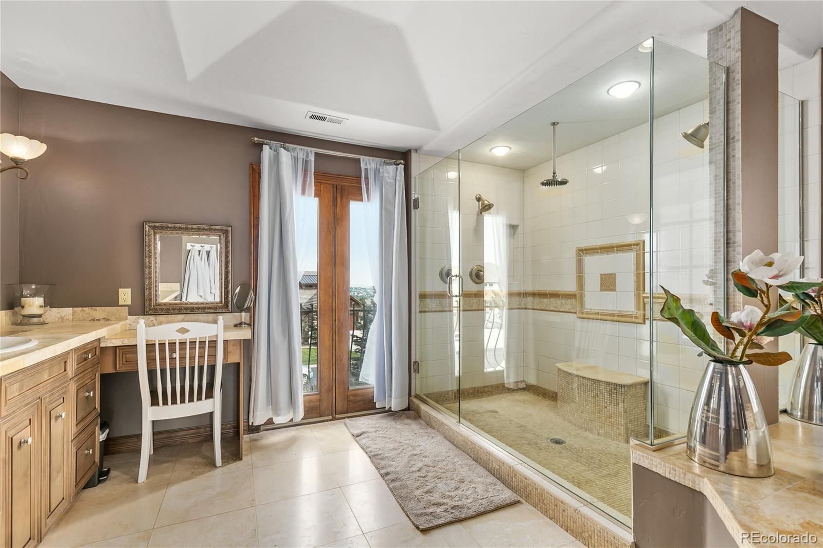 1295 Buffalo Ridge Road Castle Pines, CO 80108 - Photo 13 of 29 a bathroom with a tub a sink and glass door