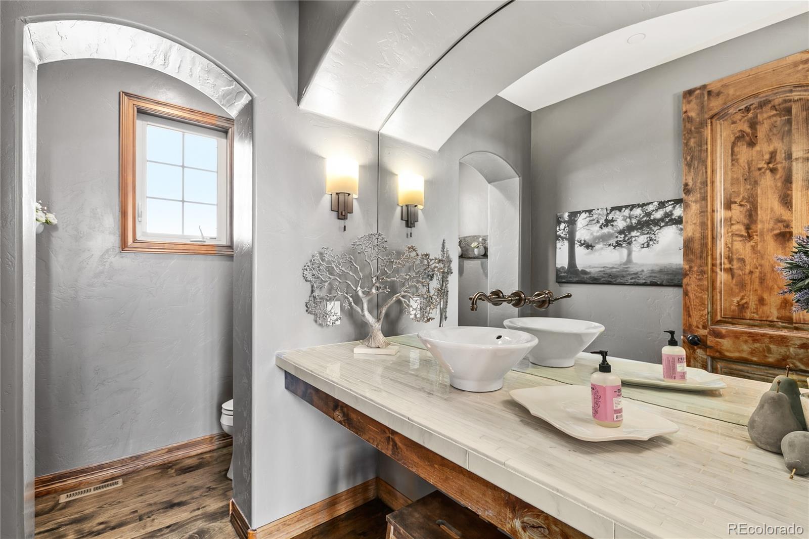 1295 Buffalo Ridge Road Castle Pines, CO 80108 - Photo 14 of 29 a dining room with wooden floor and windows