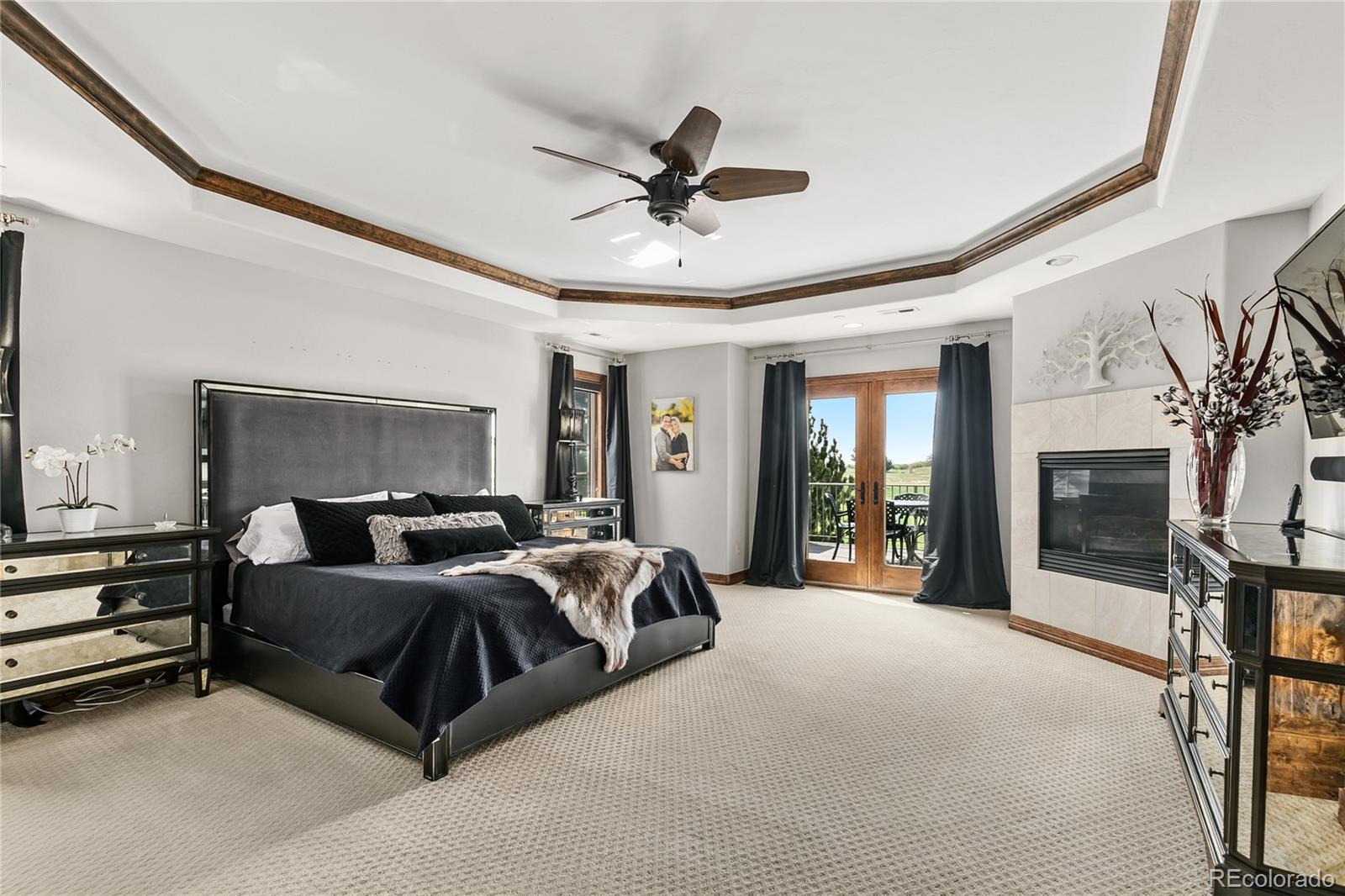 1295 Buffalo Ridge Road Castle Pines, CO 80108 - Photo 15 of 29 a living room with a bed furniture and a flat screen tv
