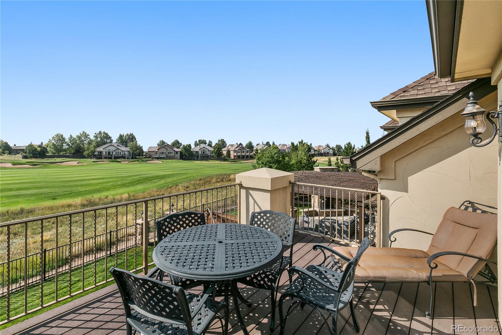 1295 Buffalo Ridge Road Castle Pines, CO 80108 - Photo 17 of 29 a view of a chair and table on the deck