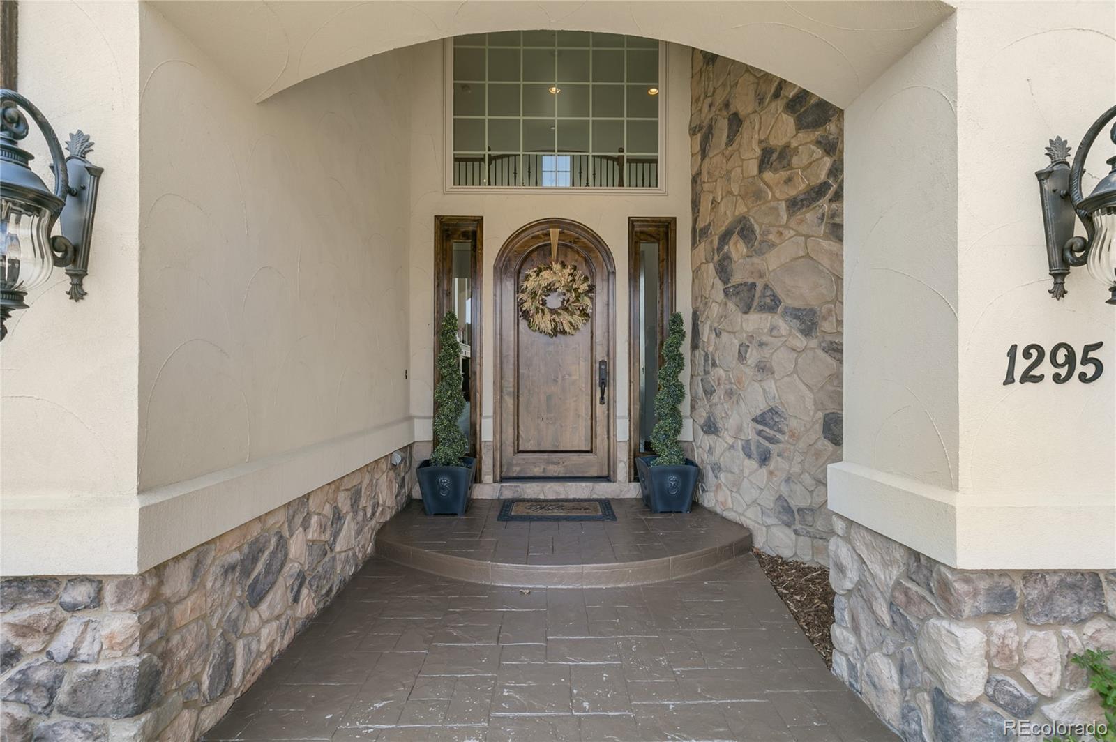 1295 Buffalo Ridge Road Castle Pines, CO 80108 - Photo 2 of 29 a view of entryway with a front door