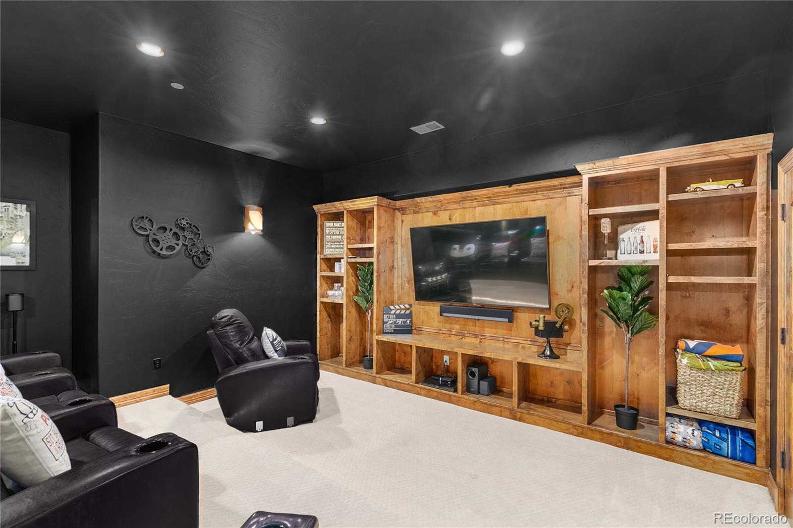 1295 Buffalo Ridge Road Castle Pines, CO 80108 - Photo 21 of 29 a living room with furniture and a flat screen tv