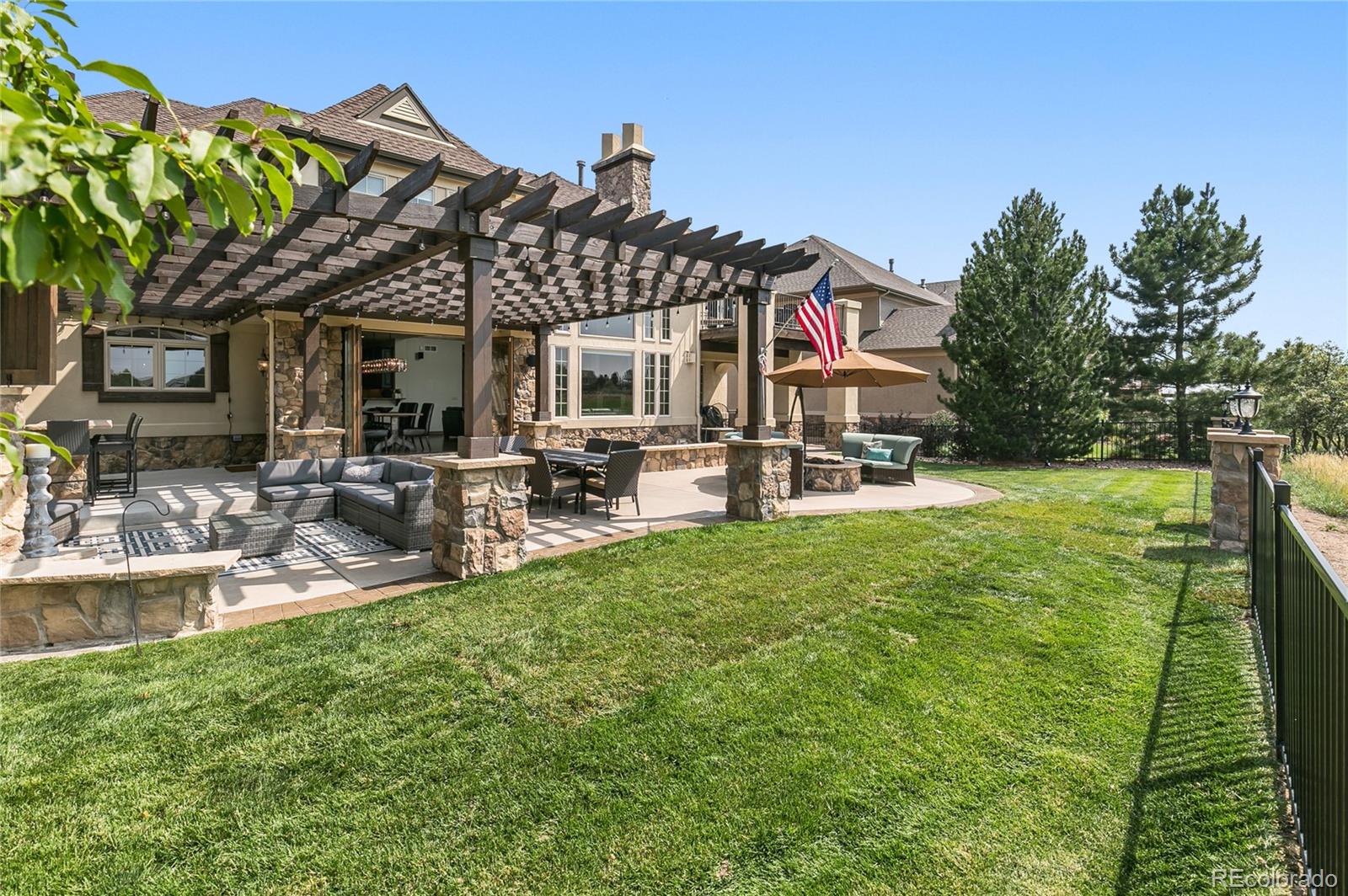 1295 Buffalo Ridge Road Castle Pines, CO 80108 - Photo 24 of 29 a front view of a house with garden and sitting area