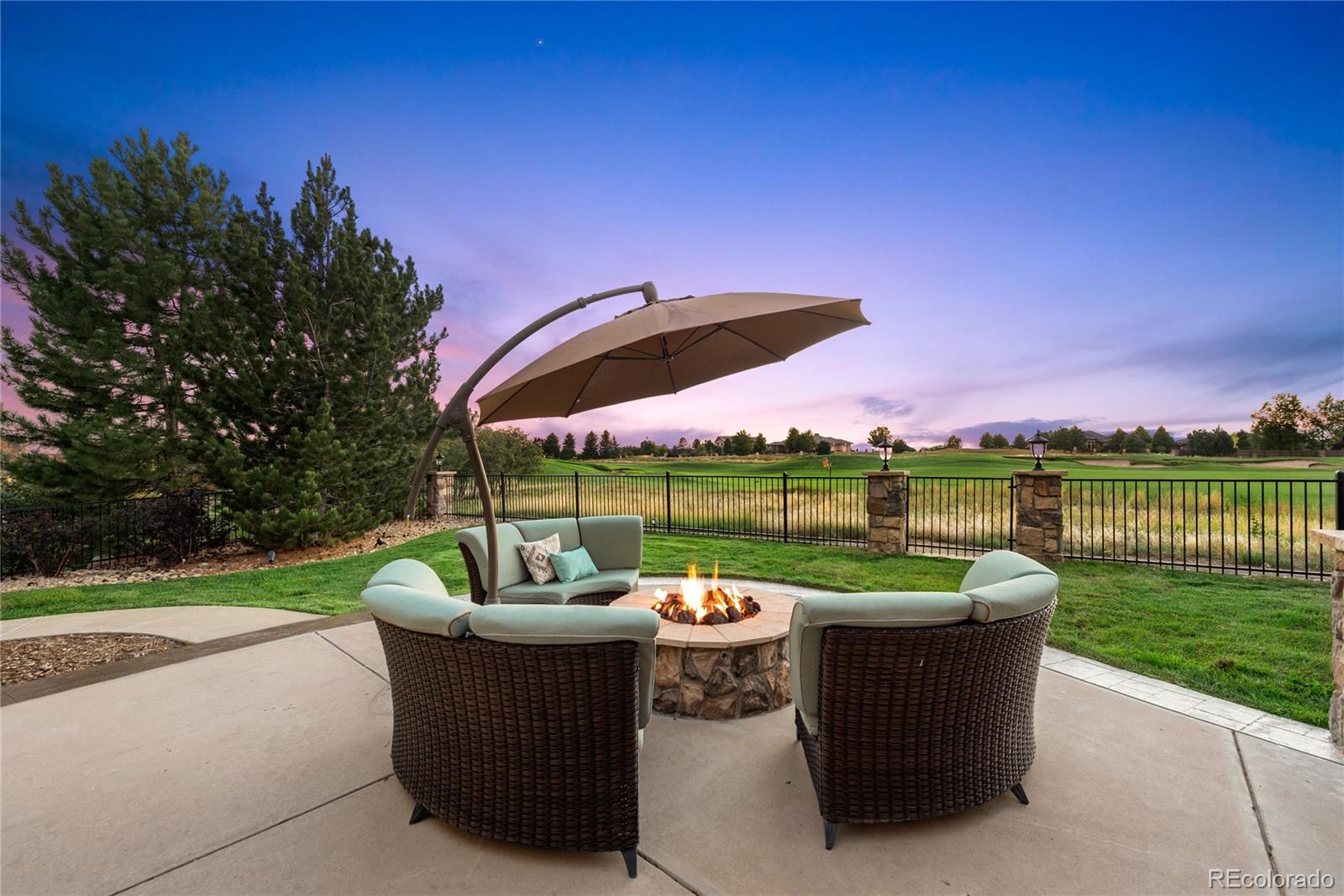 1295 Buffalo Ridge Road Castle Pines, CO 80108 - Photo 29 of 29 a swimming pool with outdoor seating and yard
