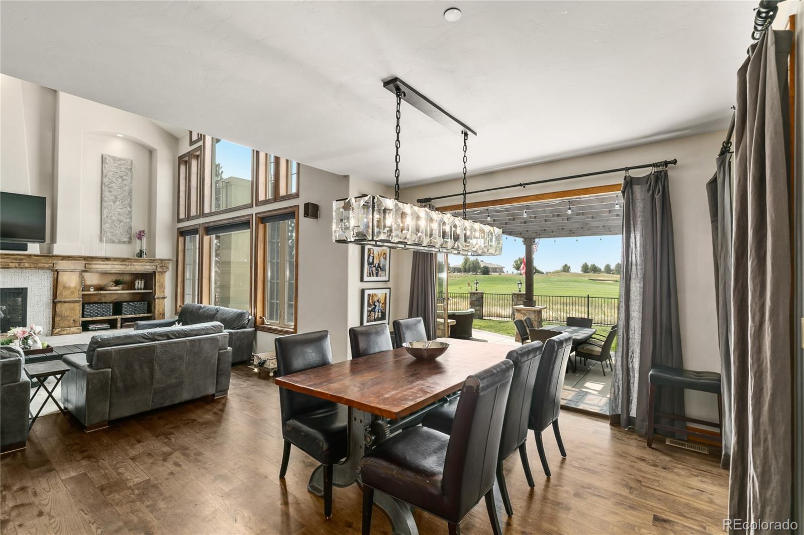 1295 Buffalo Ridge Road Castle Pines, CO 80108 - Photo 7 of 29 a view of a dining room with furniture window and wooden floor