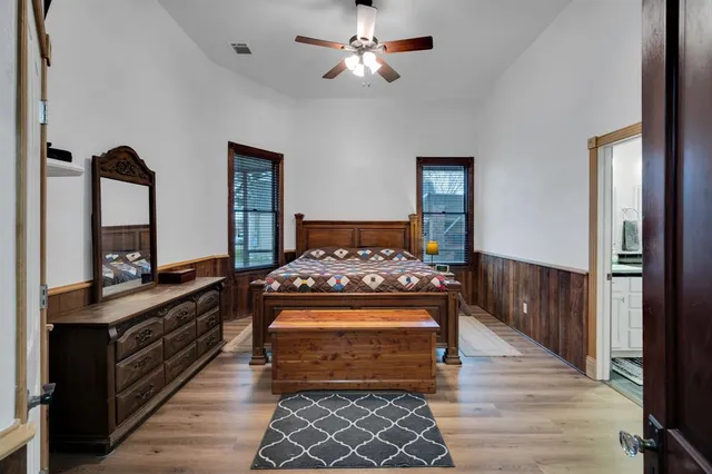 a bedroom with a bed and a chandelier