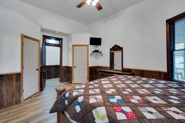 a bedroom with a bed and a chandelier