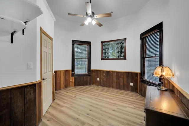 a view of a bedroom with furniture and window