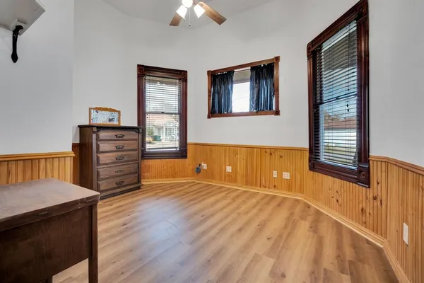 a view of a bedroom with furniture and window