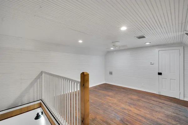 a view of hallway with wooden floor