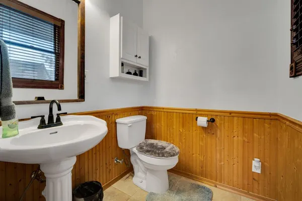 a bathroom with a sink a toilet and mirror