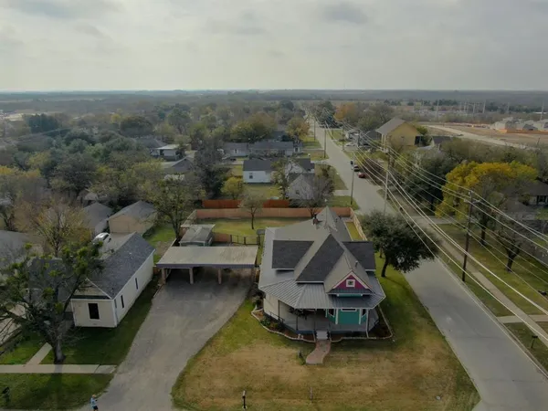 an aerial view of a house with a yard