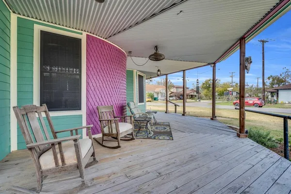 a view of chairs and tables in patio with wooden floor