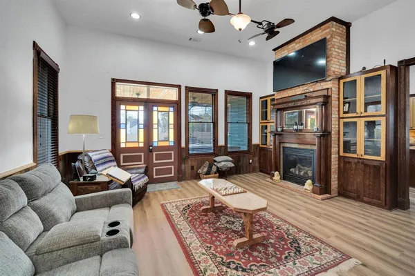 a living room with furniture fireplace and flat screen tv