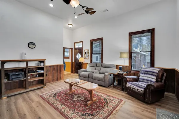 a living room with furniture and wooden floor