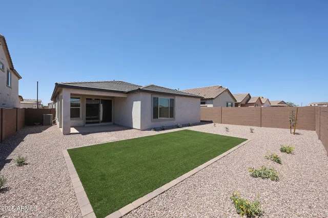 a front view of a house with a garden and yard
