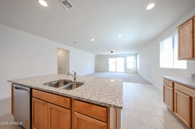 a kitchen with granite countertop a sink and a window
