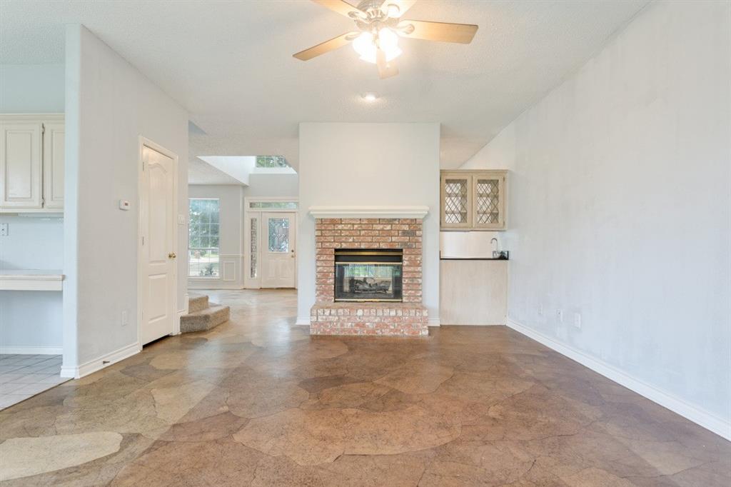 4709 Portrait Lane Plano, TX 75024 - Photo 12 of 22 Comfortable Family room featuring double sided fireplace and wet bar.