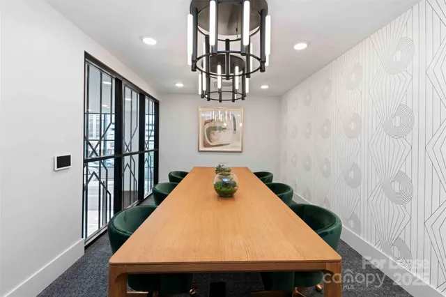 a table room with a table chairs and entryway