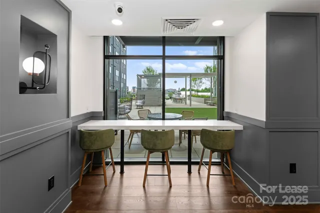 a table and chairs in a room with a mirror