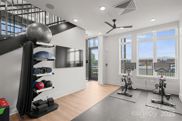 a bedroom with furniture and a large window