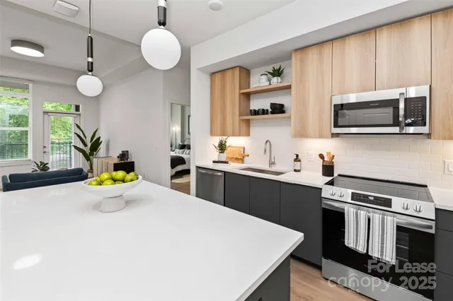 a kitchen with a stove a sink and microwave
