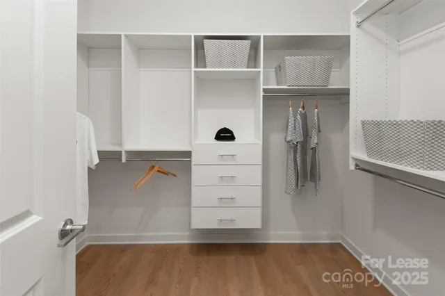 a view of walk in closet with empty racks