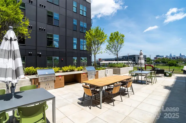 a view of a patio with couches table and chairs and potted plants