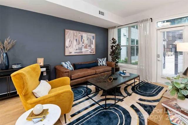 a living room with furniture and a wooden floor