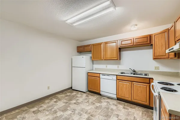 a kitchen with stainless steel appliances a sink stove and cabinets